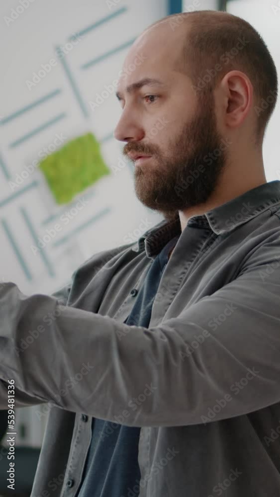 Poster vertical video: close up of man architect looking at building model and maquette to design urban pro