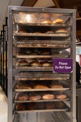 Rack trolley with freshly baked bread at supermarket.