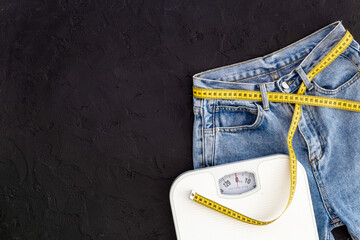 Jeans with measuring tape belt slimming with scales. Weight loss concept