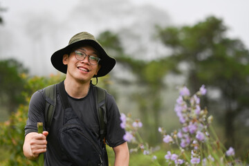 Young Asian adventurer enjoying a walk in the forest and fog.