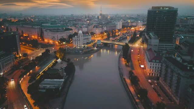 Vienna aerial skyline view at night, Austria vienna night view of old town, wien downtown river bridge cathedral church top view from sky, drone video in 4k.