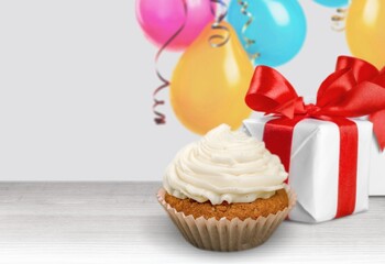 Tasty sweet cupcake and presents for birthday party