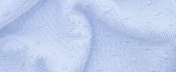 blue dot stitch knitting pattern. Wavy texture of woolen fabric. Textiles for making winter blankets