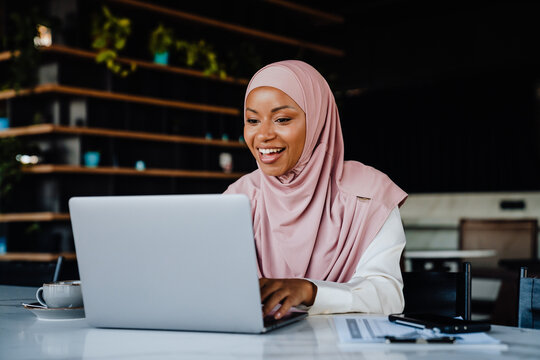 Young Muslim Woman Wearing Headscarf Working On Laptop In Office