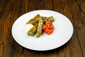 delicious pancakes with salted salmon on a plate.

