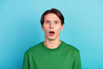 Portrait of astonished guy open mouth look incedible unbelievable message isolated blue color...