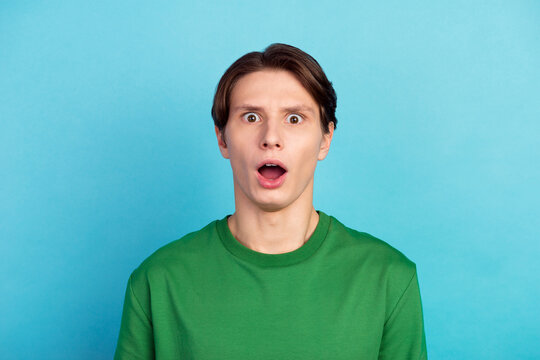 Portrait of astonished guy open mouth look incedible unbelievable message isolated blue color background