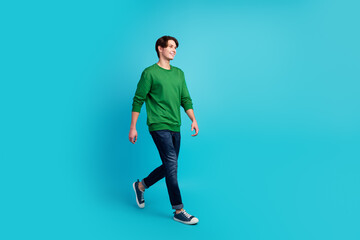 Fototapeta na wymiar Full size photo of positive cheerful man have free time walk wear casual clothes isolated blue background