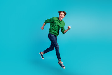 Fototapeta na wymiar Full length photo of running jumping crazy man run in shoes for sales isolated vivid color background