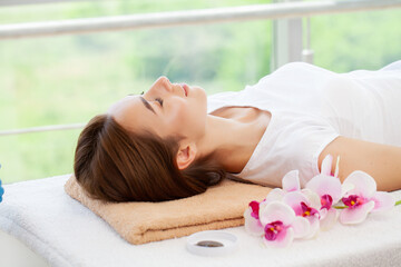 Fototapeta na wymiar Close-up of young woman getting spa massage treatment at beauty spa salon.