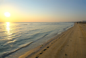 sunrise at the sandy beach.  Coastline, horizontal line, natural background. Sun rising 