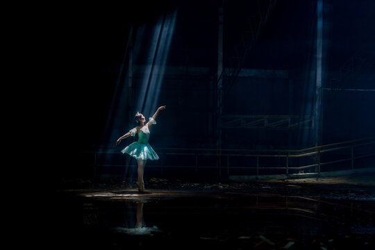 A young ballerina with a perfect body is dancing in a photo studio, dancers are dressed in fashionable outfits, this picture is taken in minimal style, showing the beauty of classical art like ballet.