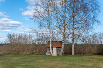 Fototapeta premium Little tiny lonely wooden house far away from city