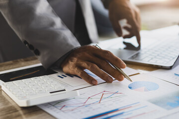 Businessman working on laptop, analyzing business growth marketing report. Business and financial strategy planning.