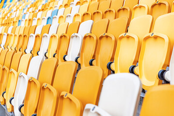 Empty stadium seats with the raised lids.