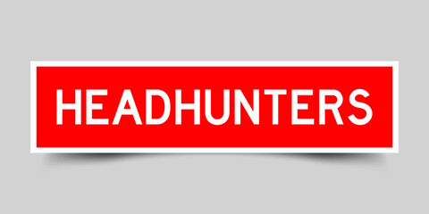 Sticker label with word headhunters in red color on gray background