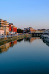 Fototapeta na wymiar view of the canal of Senigallia, Italy on the sunset over the architecture. Urban view. City postcard