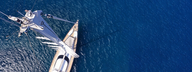 Aerial drone ultra wide panoramic photo with copy space of beautiful sail boat anchored in deep...
