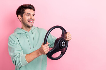 Profile photo of cheerful person arms hold wheel look empty space isolated on pink color background