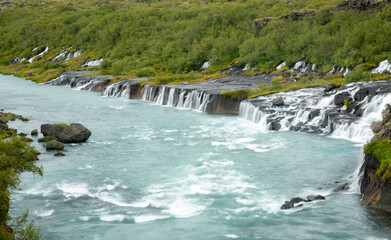Hraunfossar, or "Lava Falls", is a series of small waterfalls located in west Iceland