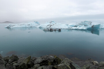 Large blue icebergs float in the Jokulsarlon Glacier Lagoon in southeast Iceland