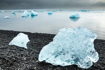 Small icebergs wash ashore on Diamond Beach on the south coast of Iceland