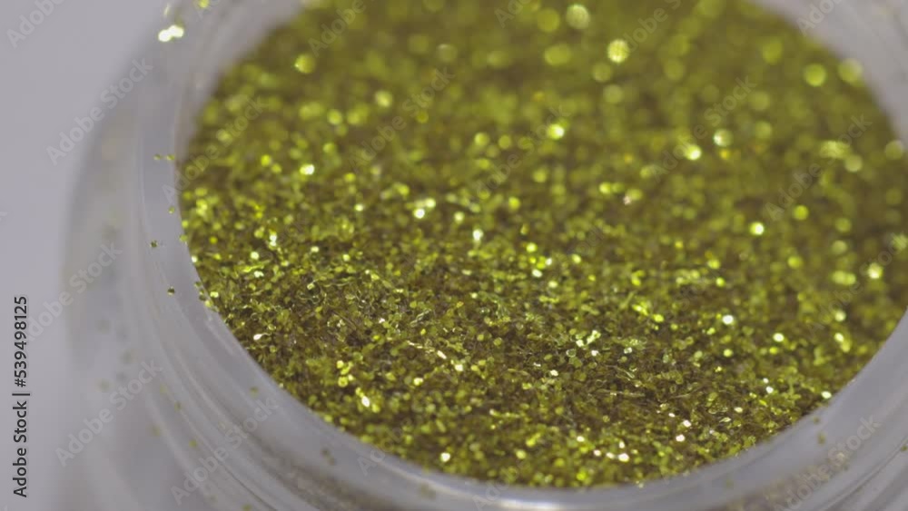 Poster golden sequins in a jar rotate in a circle