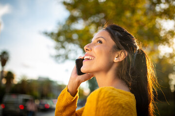 side portrait happy woman talking with mobile phone