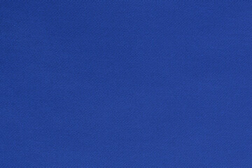 Texture of natural deep blue color twill fabric close-up. the background for your mockup