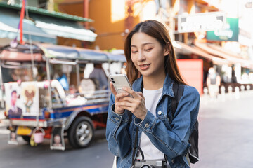 Backpacker journey destination concept, Young tourism student traveling city tour at market street in Southeast Asia during the summer vacation trip.