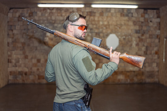Male shooter with rifle svt 40 in shooting range.