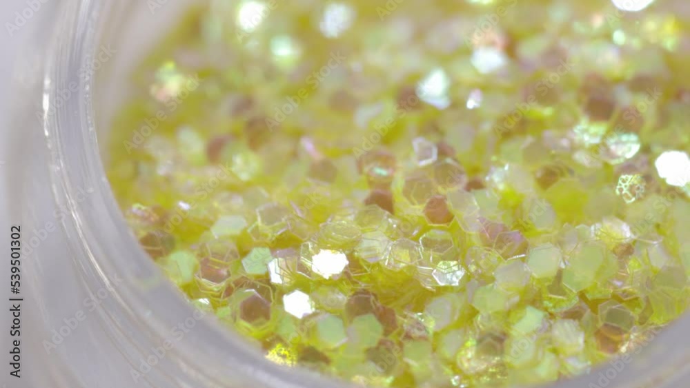 Poster golden sequins in a jar rotate in a circle