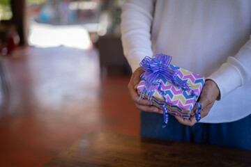 man's hands hold christmas or new year decorated gift box. .