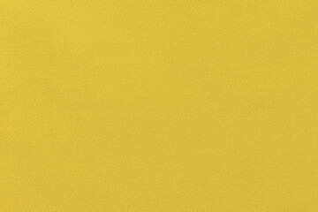 Texture of mustard twill fabric close-up. The background for your mockup