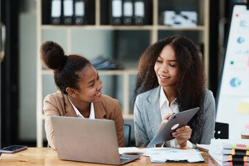 African American Businesswoman Using Laptop In Modern Office.