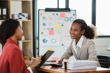 two women discussing business plans in the office