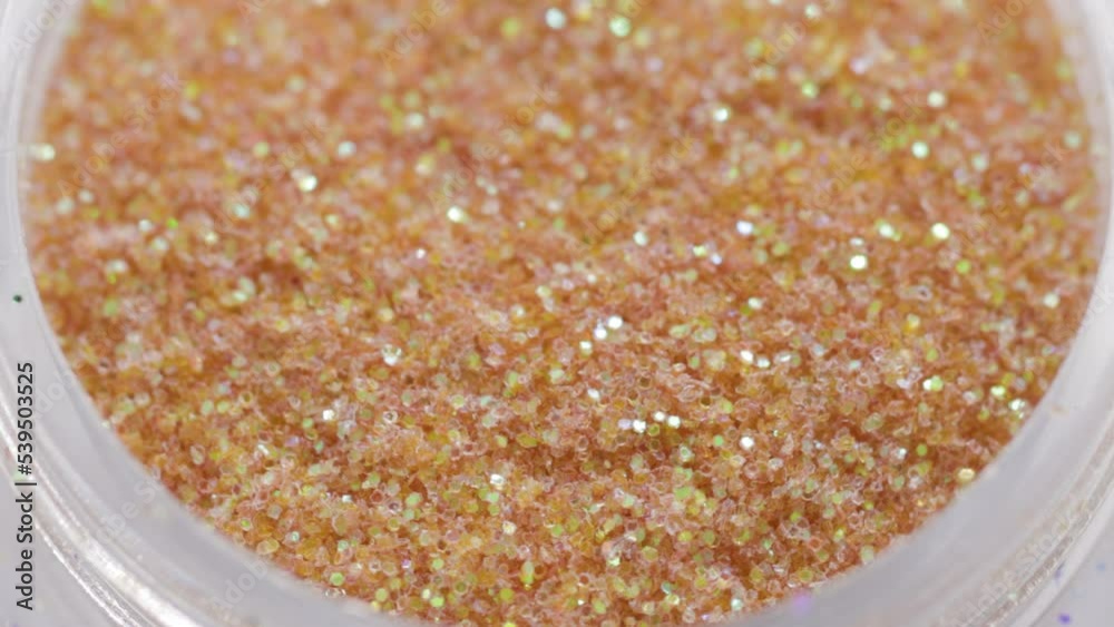Poster golden sequins in a jar rotate in a circle