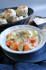 Creamy chicken stew served with fresh-baked biscuits.