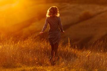 woman in a field
Young woman enjoying the sunset in the meadow