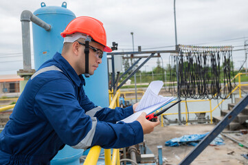 Water plant maintenance technicians, mechanical engineers check the control system at the water treatment plant.