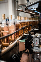 Industrial wine bottling plant theme. Modern industry production line for alcohol drink bottling and packaging.