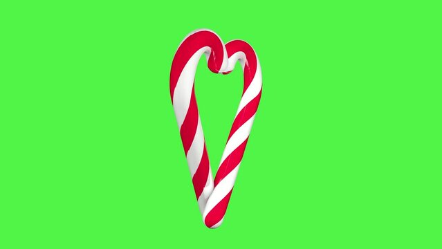 Christmas lollipops in the form of a heart on a green screen background. Seamless 3D animation. Christmas video effect. Christmas concept.