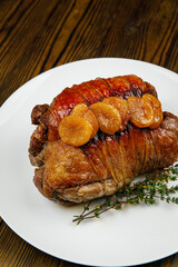 baked meat, pork on a wooden table
