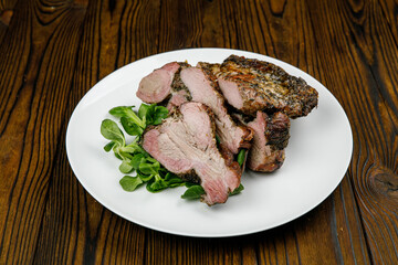 baked meat, pork on a wooden table
