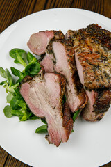 baked meat, pork on a wooden table
