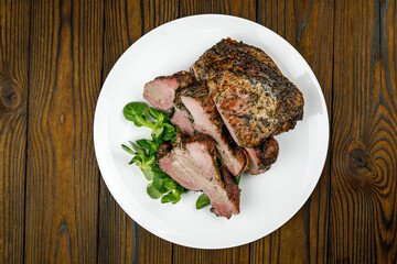 baked meat, pork on a wooden table
