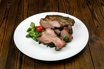 baked meat, pork on a wooden table
