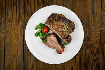 baked meat, pork on a wooden table
