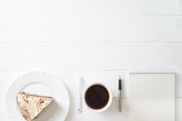 morning business breakfast. on the table coffee, cake, notepad, pen.