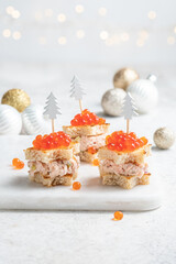 Christmas tree canape with Smoked Salmon, Cream Cheese, Dill, Horseradish Pate and red caviar for...